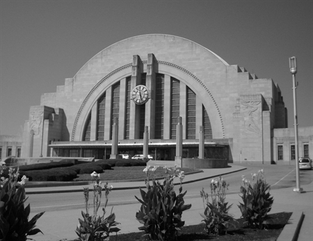Cincinnati Union Terminal's iconic Art Deco facade with arched entrance, vertical fluting, clock tower, and landscaped plaza in black and white